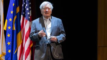 Michael E. Jung on stage presenting his faculty research lecture. 