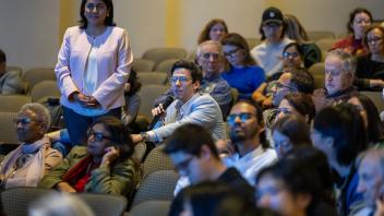 Audience member asking a question at lecture