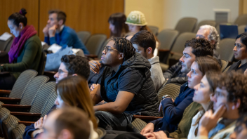 Student engaged in 135th Faculty Research Lecture given by Professor Dana Cuff